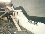 Parging applied (at grade level) and Stucco basecoat above